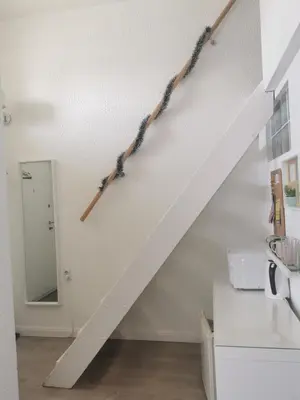 a white staircase with two ropes on the wall at - WHITE - white&black Apartmans-Free parking- in Belgrade