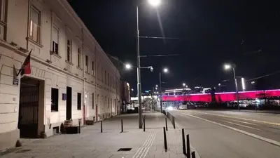 an empty city street at night with a pink train at - WHITE - white&black Apartmans-Free parking- in Belgrade