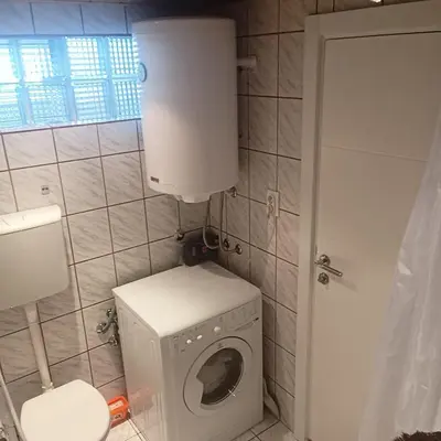a bathroom with a washing machine and a toilet at - WHITE - white&black Apartmans-Free parking- in Belgrade