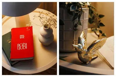 a table with a lamp a book and a bird statue at Harmonic Nest 3min to Republic Square Renovated in Belgrade
