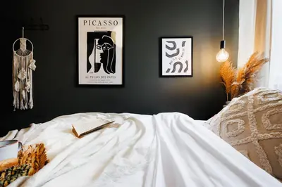 a bedroom with two posters on the wall and a bed at Harmonic Nest 3min to Republic Square Renovated in Belgrade
