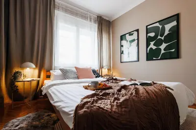 a bedroom with a bed with a table on it at Harmonic Nest 3min to Republic Square Renovated in Belgrade
