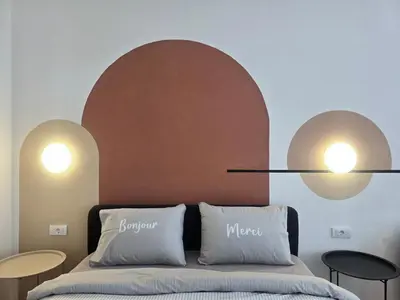 a bedroom with two lamps above a bed at Boneca apartment in Belgrade