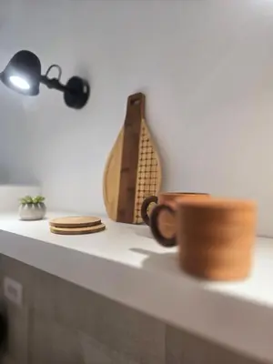 a table with two cups and a lamp and a guitar at Boneca apartment in Belgrade