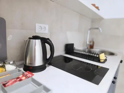 a tea kettle sitting on top of a kitchen counter at Boneca apartment in Belgrade