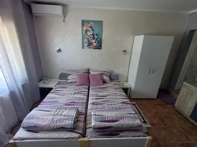 a bedroom with a bed with purple sheets at Apartments DAJER in Arandjelovac
