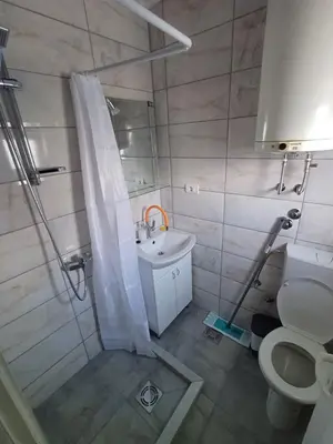 a bathroom with a shower and a sink and a toilet at Apartments DAJER in Arandjelovac