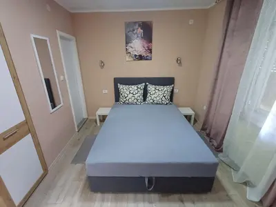 a bedroom with a blue bed in a room at Apartments DAJER in Arandjelovac