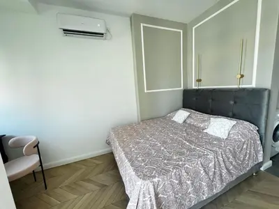 a small bedroom with a bed and a window at The city spot in Belgrade