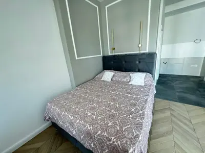 a bedroom with a bed with a gray comforter at The city spot in Belgrade
