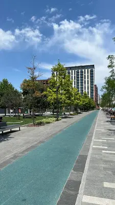 a empty street with benches and a building at Waterfront Nights in Belgrade