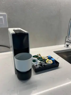 a cell phone sitting next to a cup on a counter at Waterfront Nights in Belgrade