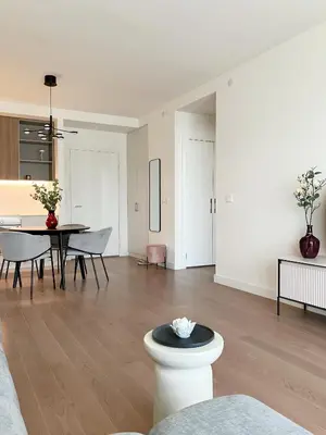 a living room with a table and a dining room at Waterfront Nights in Belgrade