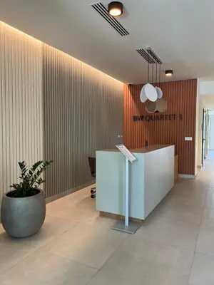 an office lobby with a reception desk and a plant at Waterfront Nights in Belgrade