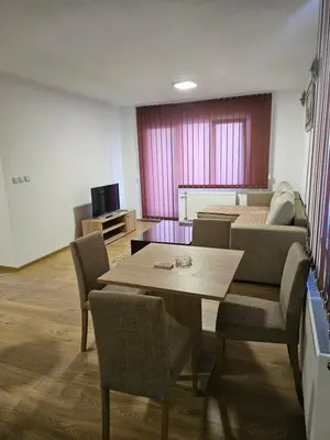 a living room with a table and a couch at EM Apart in Beograd