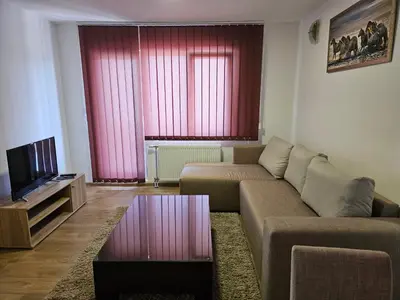 a living room with a couch and a tv at EM Apart in Beograd
