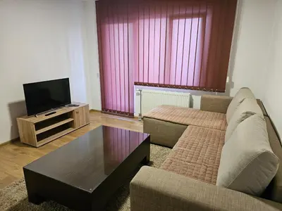 a living room with a couch and a tv at EM Apart in Beograd