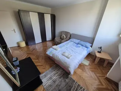 a bedroom with a bed and a chair in it at Sunny Lux Apartment Terazije in Belgrade