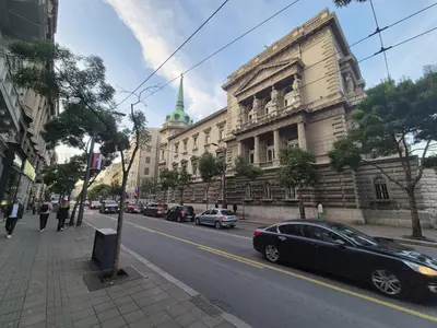 a city street with cars parked in front of a building at Sunny Lux Apartment Terazije in Belgrade