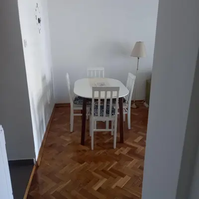 a dining room table and chairs in a room at ParkSide Apartman in Arandjelovac
