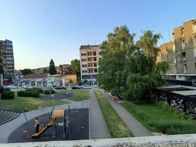 a park with a playground in a city at ParkSide Apartman in Arandjelovac