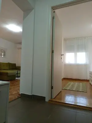 a living room with a door to a living room at ParkSide Apartman in Arandjelovac