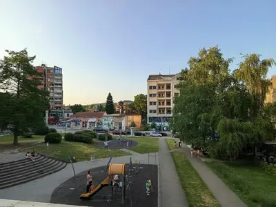 a playground with a slide in a park at ParkSide Apartman in Arandjelovac