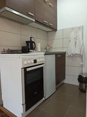 a kitchen with a black and white stove top oven at ParkSide Apartman in Arandjelovac