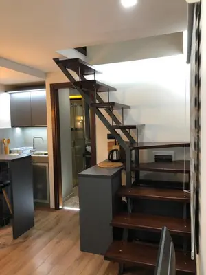 a kitchen with a spiral staircase in a room at Apartment Nevena 3 in Belgrade
