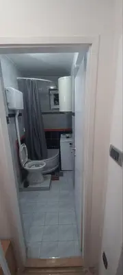 a bathroom with a toilet and a sink at Quiet garden in Belgrade