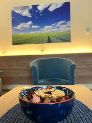 a bowl of food is sitting on a table at Guest House A'storia in Ruma