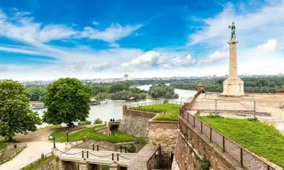 a view of the river and the statue of liberty at Kalemegdan park & Zoo - City center in Belgrade