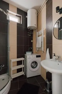 a bathroom with a washing machine and a sink at Radio Belgrade Apartment in Belgrade