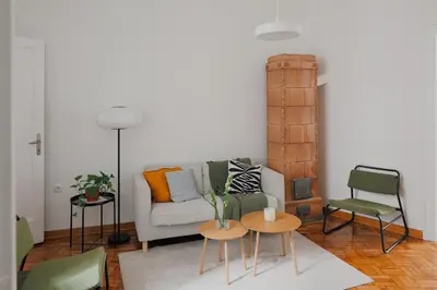 a living room with a couch and two tables at Radio Belgrade Apartment in Belgrade