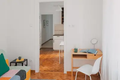 a small apartment with a desk and a bedroom at Radio Belgrade Apartment in Belgrade