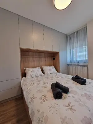 a bedroom with a bed with two pillows on it at District 21 in Belgrade