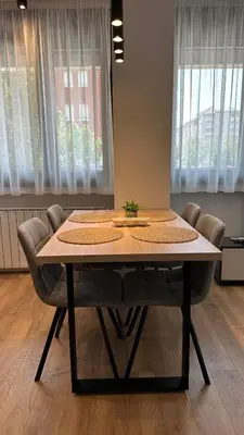 a dining room table with chairs and a tableablish at District 21 in Belgrade