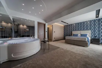 a bedroom with a large tub and a bed at Rei 2 in Belgrade