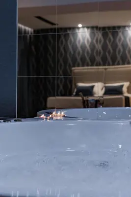 a room with a table with a mirror and a couch at Rei 2 in Belgrade