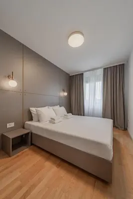 a bedroom with a large bed and a window at Rei 2 in Belgrade