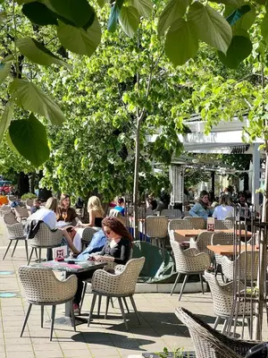 a group of people sitting in chairs in a courtyard at Luxury apartment in the heart of Vračar in Belgrade