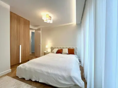 a bedroom with a white bed and a window at Luxury apartment in the heart of Vračar in Belgrade