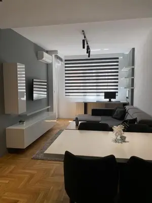 a living room with a couch and a table at Apartman Oaza in Smederevo