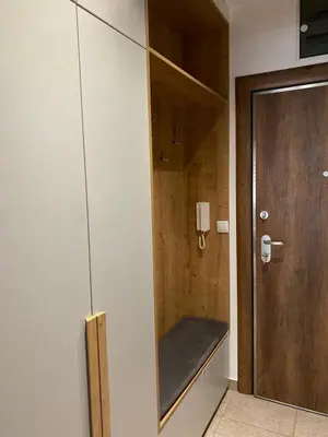 a bathroom with a bench next to a door at Apartman Oaza in Smederevo