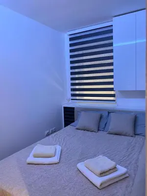 a bedroom with a bed with two towels on it at Apartman Oaza in Smederevo