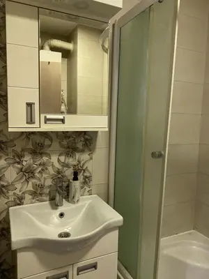 a bathroom with a sink and a shower at Apartman Oaza in Smederevo