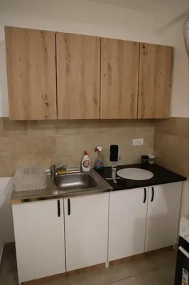 a kitchen with a sink and a counter top at Zmaj LUX in Mladenovac
