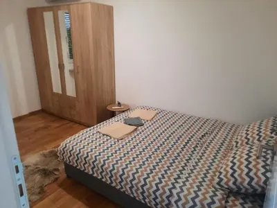 a bedroom with a bed with a laptop on it at Zmaj LUX in Mladenovac