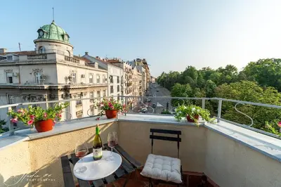 a balcony with a table and chairs on a balcony at The View That Never Gets Old - Kalemegdan in Belgrade