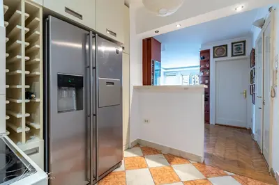 a kitchen with a refrigerator and a tile floor at The View That Never Gets Old - Kalemegdan in Belgrade
